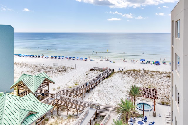 property view of water featuring a beach view and fence