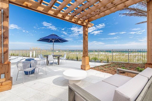 view of patio featuring outdoor dining area, a water view, and a pergola