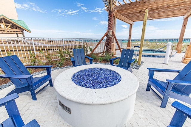 view of patio featuring a water view, an outdoor hot tub, and fence