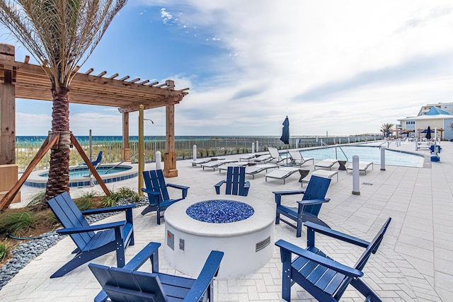 view of patio / terrace with a fire pit, a community pool, fence, and a pergola