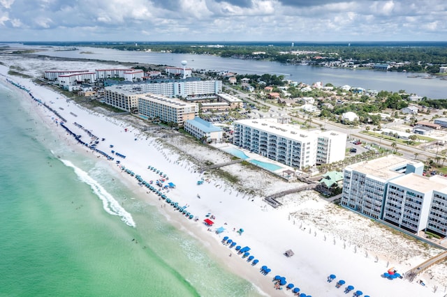 drone / aerial view featuring a view of city, a beach view, and a water view