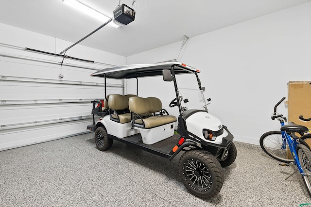 garage with baseboards and a garage door opener