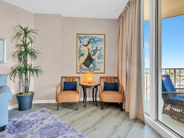 living area featuring wood finished floors and baseboards