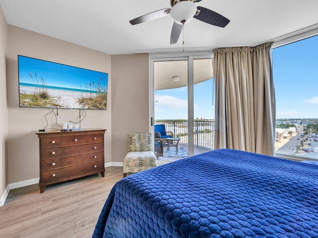 bedroom with a ceiling fan, access to exterior, light wood-style floors, and baseboards