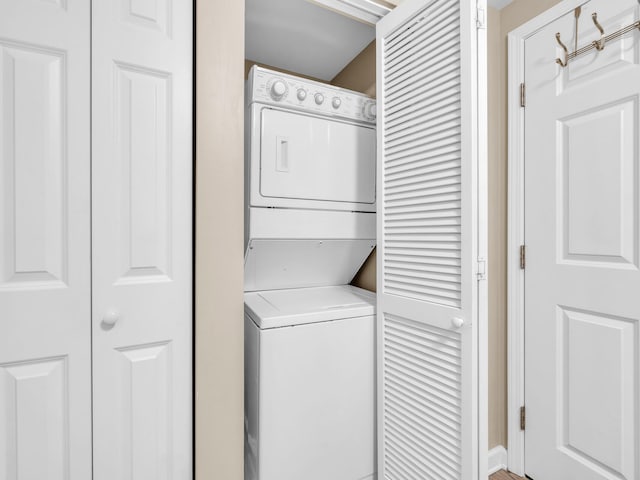 laundry room featuring laundry area and stacked washer / dryer