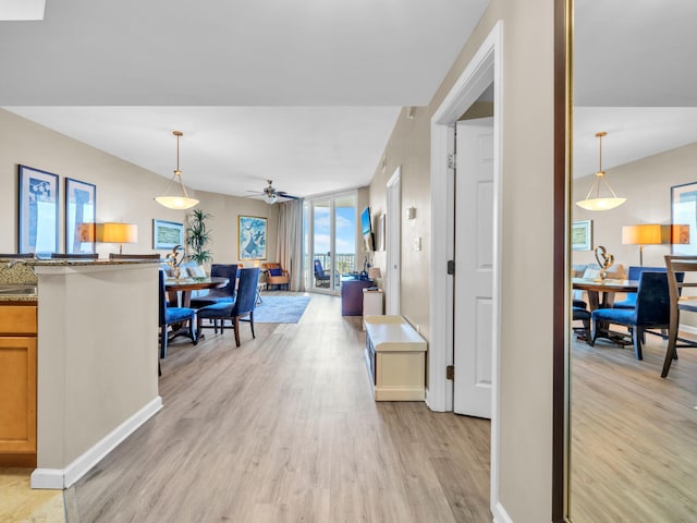 interior space featuring floor to ceiling windows and light wood-style floors