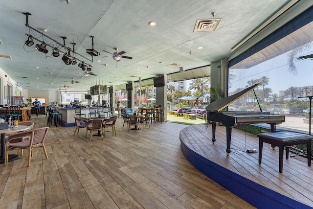 deck featuring outdoor dining space, a ceiling fan, and visible vents