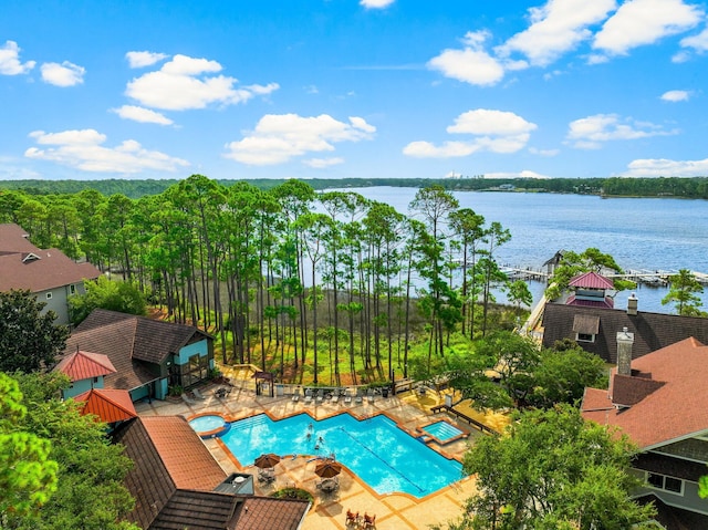 view of swimming pool featuring a water view, a patio area, and a fenced in pool