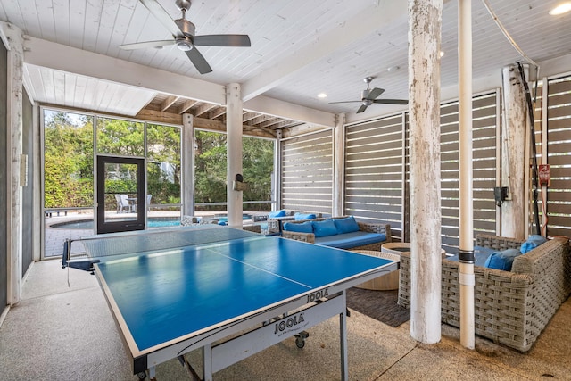 playroom featuring wooden ceiling, beam ceiling, and a ceiling fan