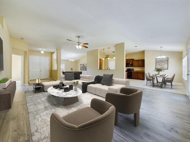 3098 Border Creek Dr, Crestview, FL 32539 - living area featuring a chandelier, lofted ceiling, light wood-style flooring, and baseboards