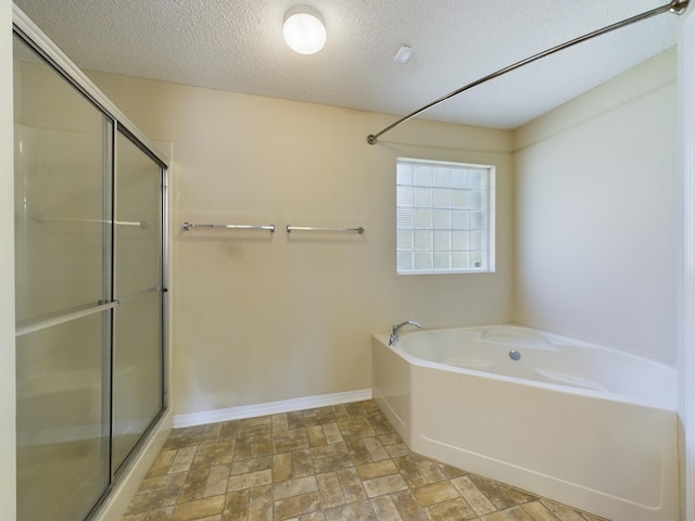 3098 Border Creek Dr, Crestview, FL 32539 - full bathroom featuring a garden tub, an enclosed shower, baseboards, and a textured ceiling