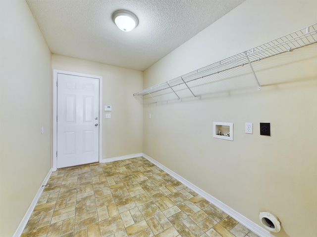 3098 Border Creek Dr, Crestview, FL 32539 - clothes washing area with hookup for a washing machine, electric dryer hookup, a textured ceiling, laundry area, and baseboards