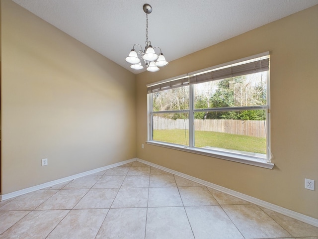 3098 Border Creek Dr, Crestview, FL 32539 - empty room featuring baseboards, light tile patterned floors, a textured ceiling, and a notable chandelier