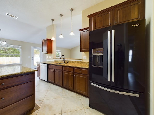 3098 Border Creek Dr, Crestview, FL 32539 - kitchen featuring a sink, black fridge with ice dispenser, stainless steel dishwasher, light stone countertops, and decorative light fixtures
