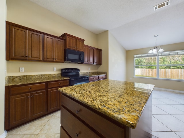 3098 Border Creek Dr, Crestview, FL 32539 - kitchen featuring lofted ceiling, a kitchen island, visible vents, black appliances, and dark stone countertops