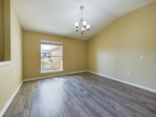 3098 Border Creek Dr, Crestview, FL 32539 - spare room with baseboards, vaulted ceiling, a chandelier, and dark wood finished floors