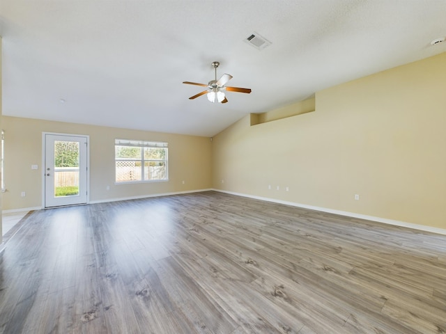 3098 Border Creek Dr, Crestview, FL 32539 - unfurnished living room with light wood-style floors, baseboards, visible vents, and vaulted ceiling