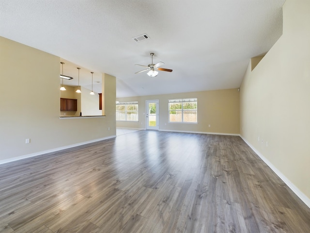 3098 Border Creek Dr, Crestview, FL 32539 - unfurnished living room with a ceiling fan, visible vents, vaulted ceiling, and wood finished floors