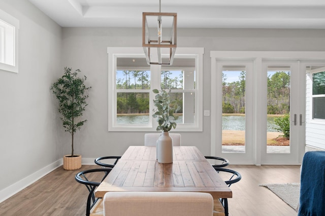 dining room with light wood-style flooring and baseboards