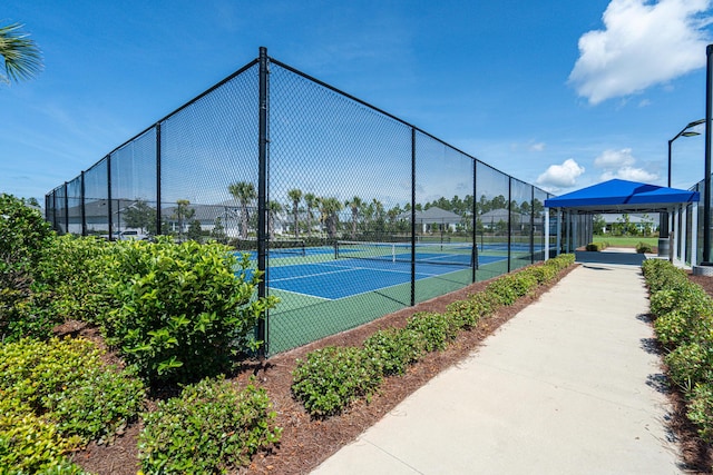 view of sport court featuring fence and a gazebo