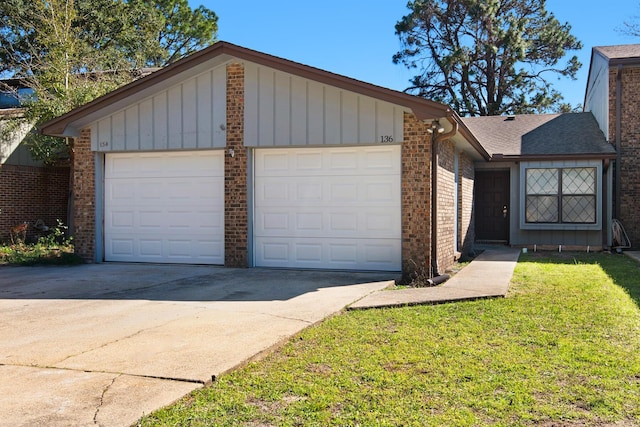 single story home with a garage, concrete driveway, a front lawn, board and batten siding, and brick siding