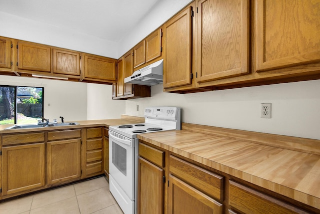 kitchen with white electric range oven, brown cabinets, light countertops, under cabinet range hood, and a sink