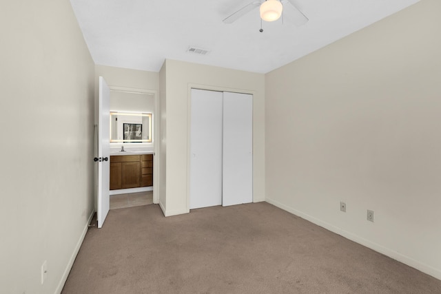 unfurnished bedroom with light carpet, baseboards, visible vents, a ceiling fan, and a closet