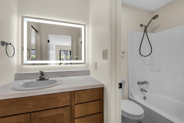 bathroom featuring toilet, vanity, and shower / tub combination