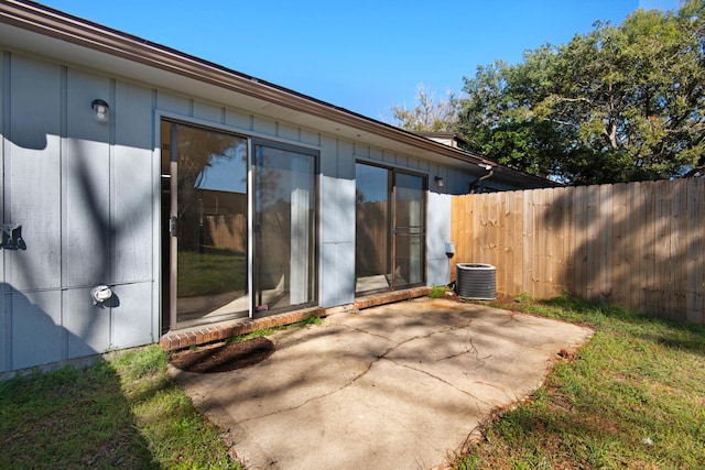 view of patio / terrace featuring central AC unit and fence