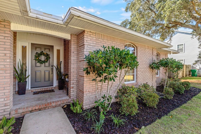 doorway to property featuring brick siding