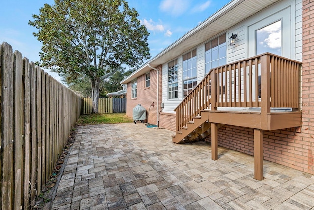 view of patio / terrace with a fenced backyard, a grill, and a wooden deck