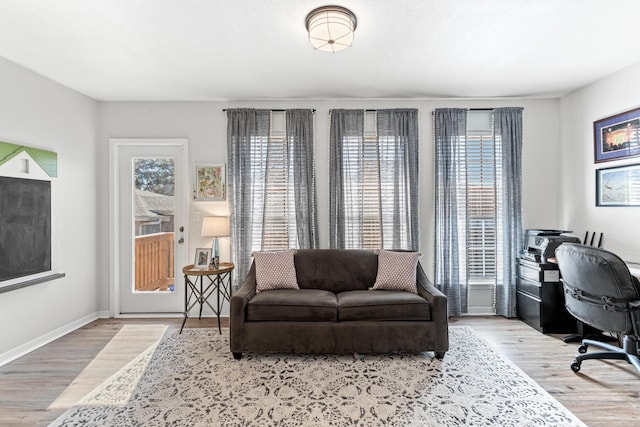 home office featuring baseboards and wood finished floors