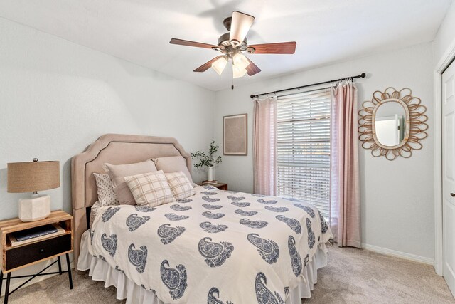 bedroom featuring carpet, baseboards, and a ceiling fan