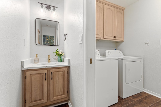 laundry room with cabinet space, dark wood-type flooring, a sink, separate washer and dryer, and baseboards