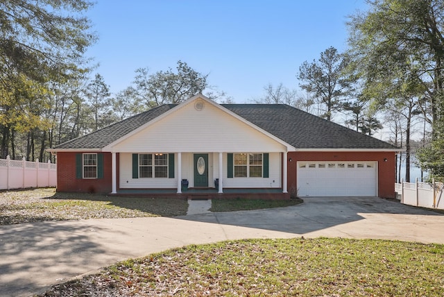 single story home featuring brick siding, a porch, an attached garage, fence, and driveway