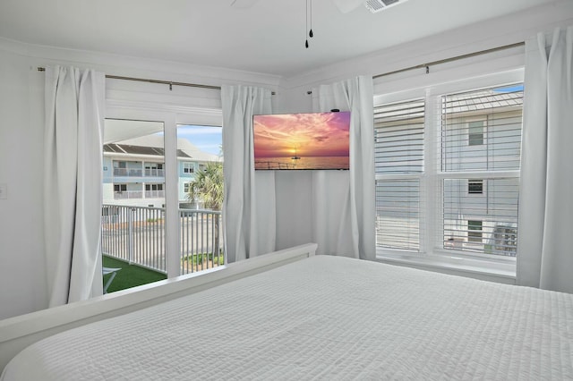 bedroom featuring access to outside, visible vents, and ceiling fan