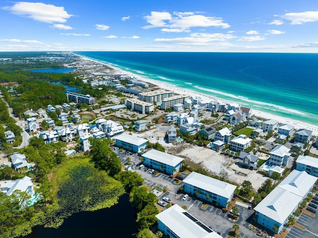 birds eye view of property featuring a water view and a beach view