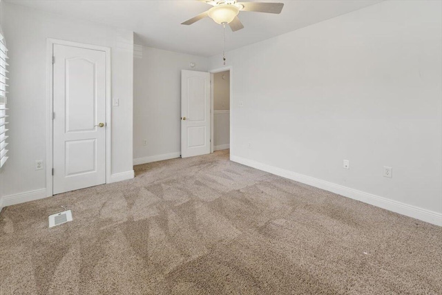 unfurnished bedroom featuring visible vents, baseboards, carpet, and ceiling fan