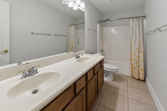 full bath featuring a sink, toilet, double vanity, and tile patterned floors