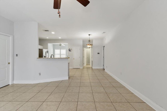 unfurnished living room with light tile patterned floors, a ceiling fan, visible vents, baseboards, and recessed lighting