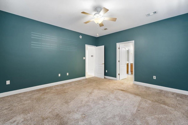 unfurnished bedroom with visible vents, baseboards, a ceiling fan, and carpet flooring