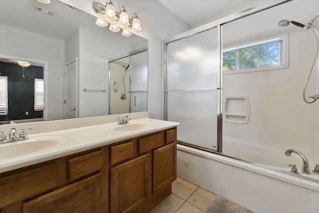 full bathroom featuring tile patterned floors, double vanity, enclosed tub / shower combo, and a sink