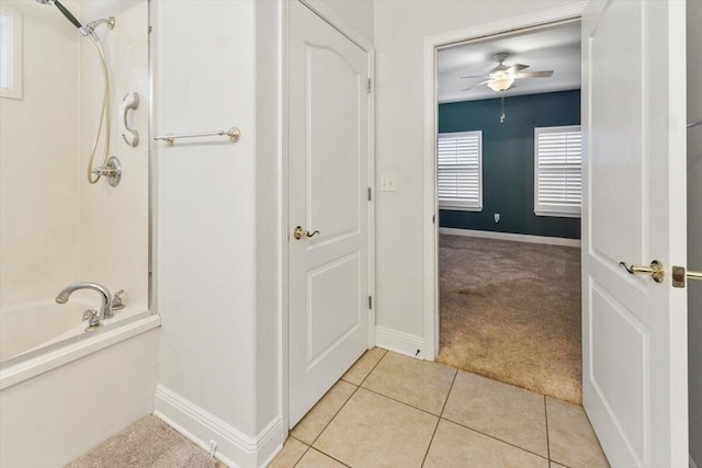 bathroom with baseboards, ceiling fan, a shower, tile patterned floors, and a bathtub