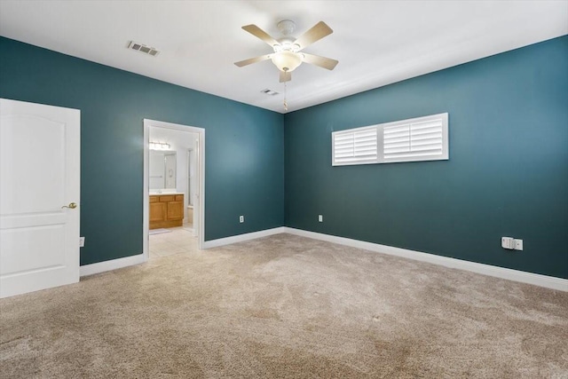 spare room featuring baseboards, visible vents, a ceiling fan, and carpet