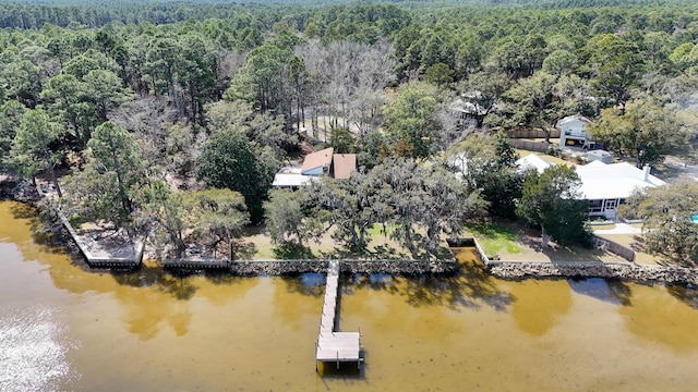 aerial view with a water view and a wooded view