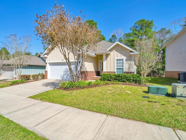 ranch-style home with a garage, concrete driveway, a front lawn, board and batten siding, and brick siding