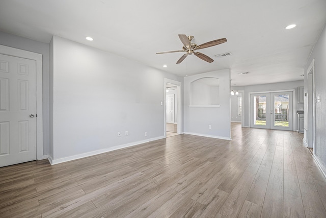 unfurnished living room with light wood-type flooring, baseboards, visible vents, and recessed lighting