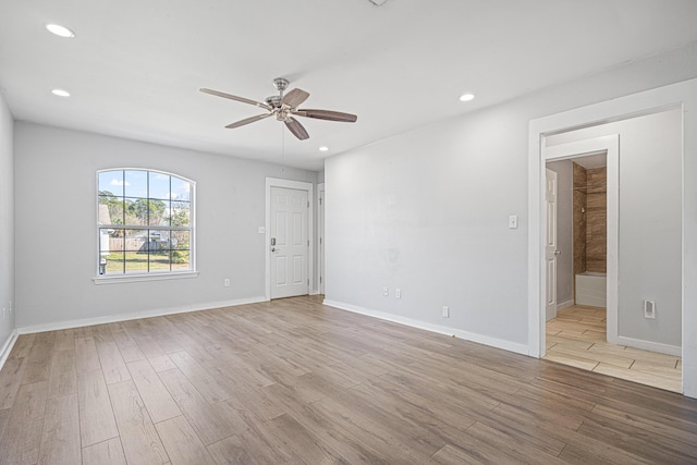 spare room featuring baseboards, a ceiling fan, light wood-style flooring, and recessed lighting