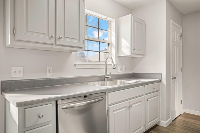 kitchen featuring a sink, white cabinetry, light countertops, and dishwasher