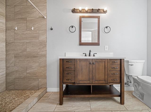 full bath with baseboards, a shower stall, toilet, and vanity